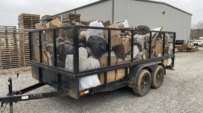 Loaded trailer full of boxes, bags and bulky junk